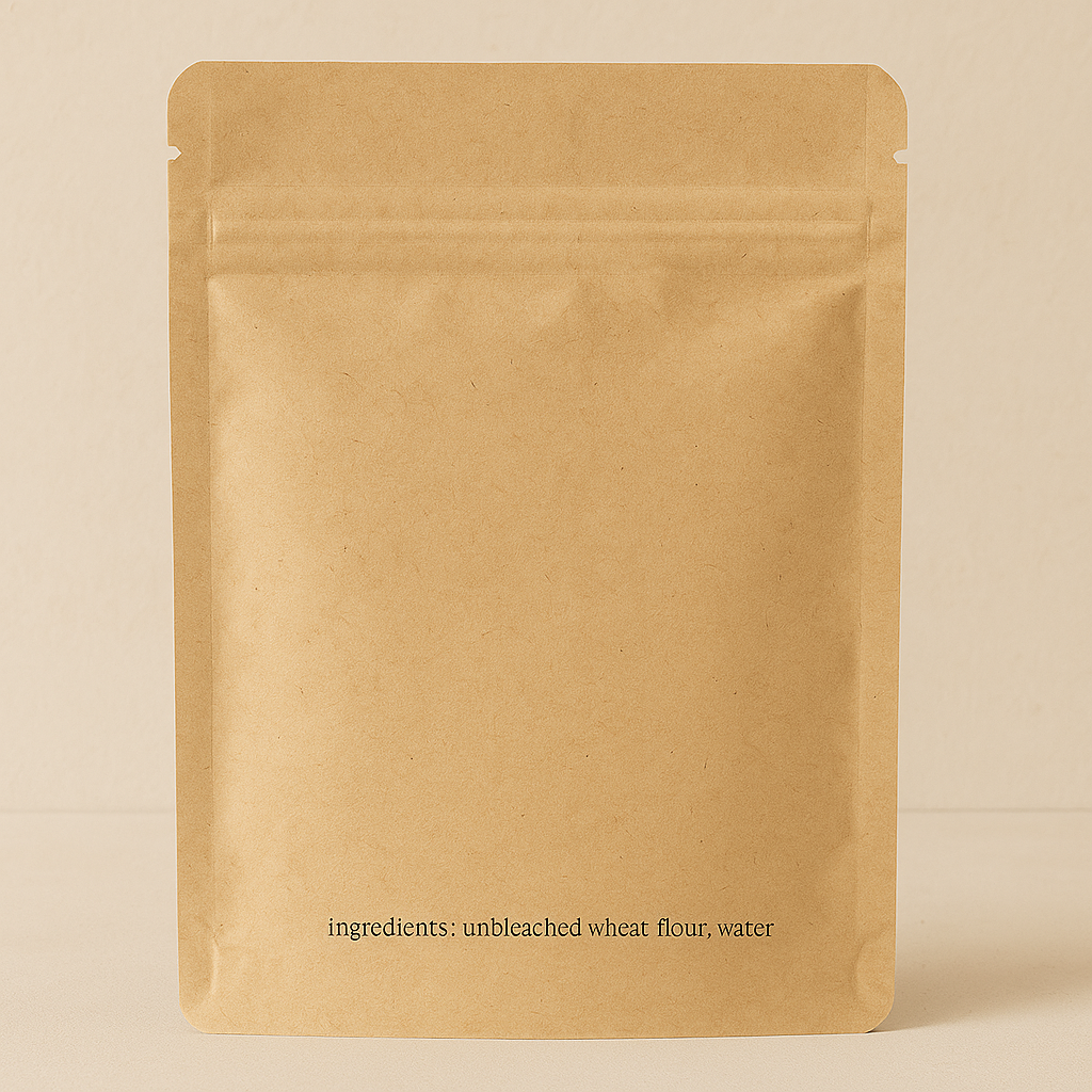 Brown paper kraft packaging with 'ingredients: unbleached wheat flour, water' text on a beige background
