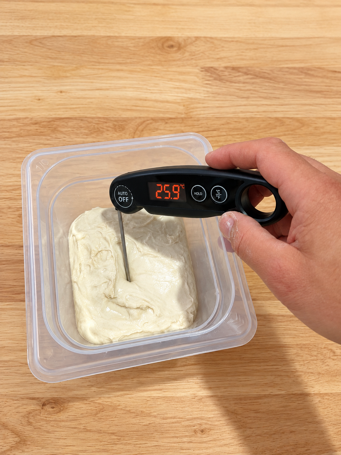Probe thermometer measuring sourdough at a final dough temperature of 25.9 degrees Celsius