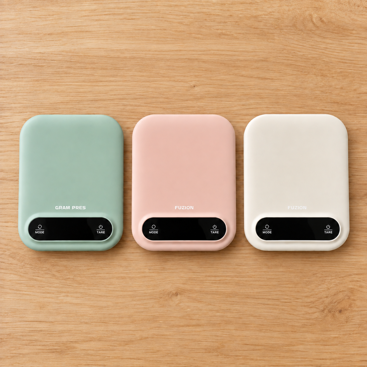 Sage, pink and white digital kitchen scales on light timber