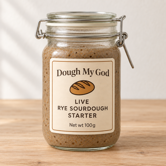 Dough My God live organic rye sourdough starter displayed in a glass jar on a timber benchtop