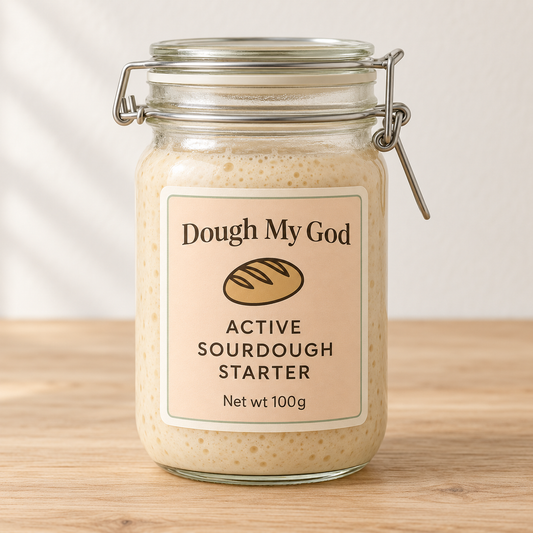 Dough My God live organic sourdough starter displayed in a glass jar on a timber benchtop