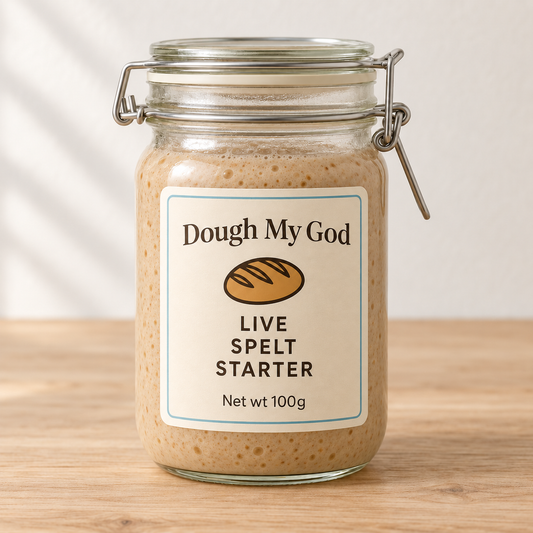 Dough My God live organic spelt sourdough starter displayed in a glass jar on a timber benchtop