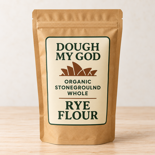 Dough My God Organic Stoneground Whole Rye Flour in a kraft pouch on a light timber surface