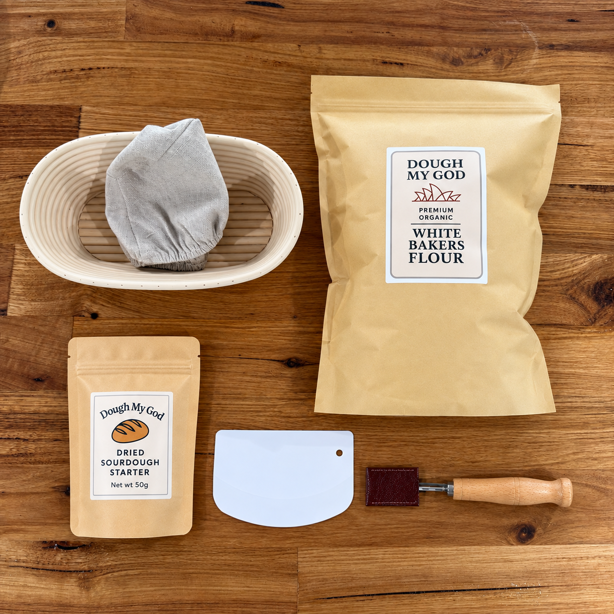 Essential sourdough starter kit with dried starter, organic bakers flour, oval banneton, dough lame and scraper