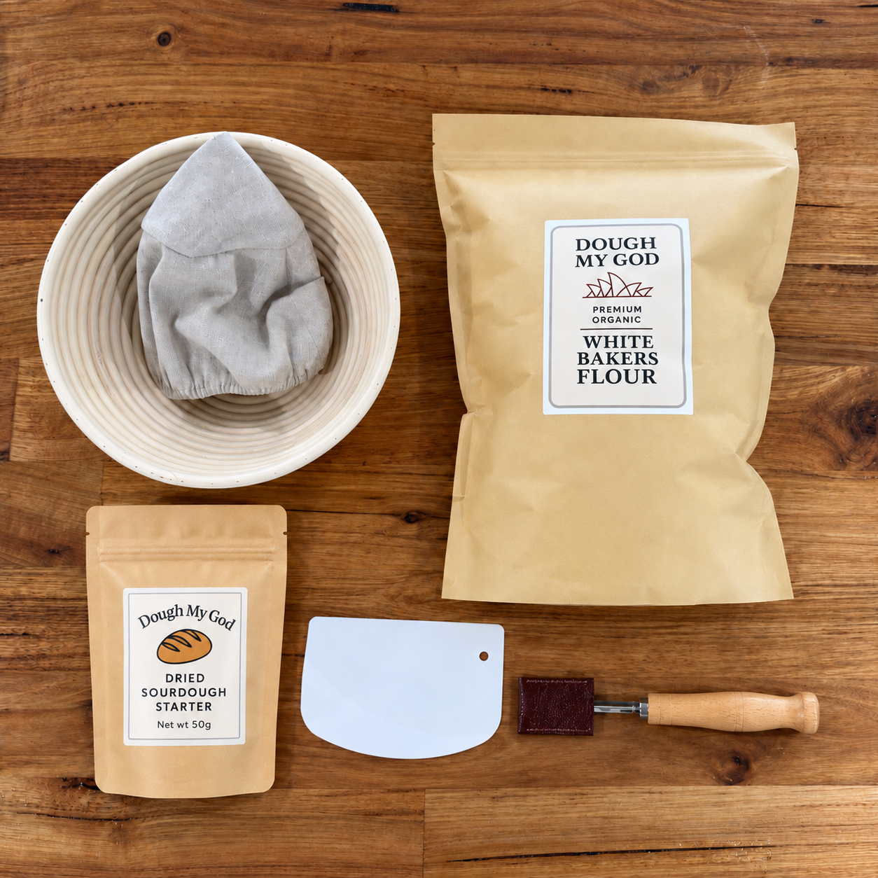 Essential sourdough starter kit with dried starter, organic bakers flour, round banneton, dough lame and scraper