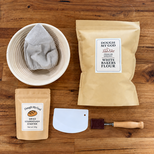 Essential sourdough starter kit with dried starter, organic bakers flour, round banneton, dough lame and scraper